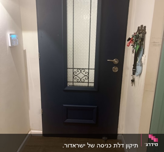 דלת כחולה עם חלון זכוכית מעוצב וידית מתכת